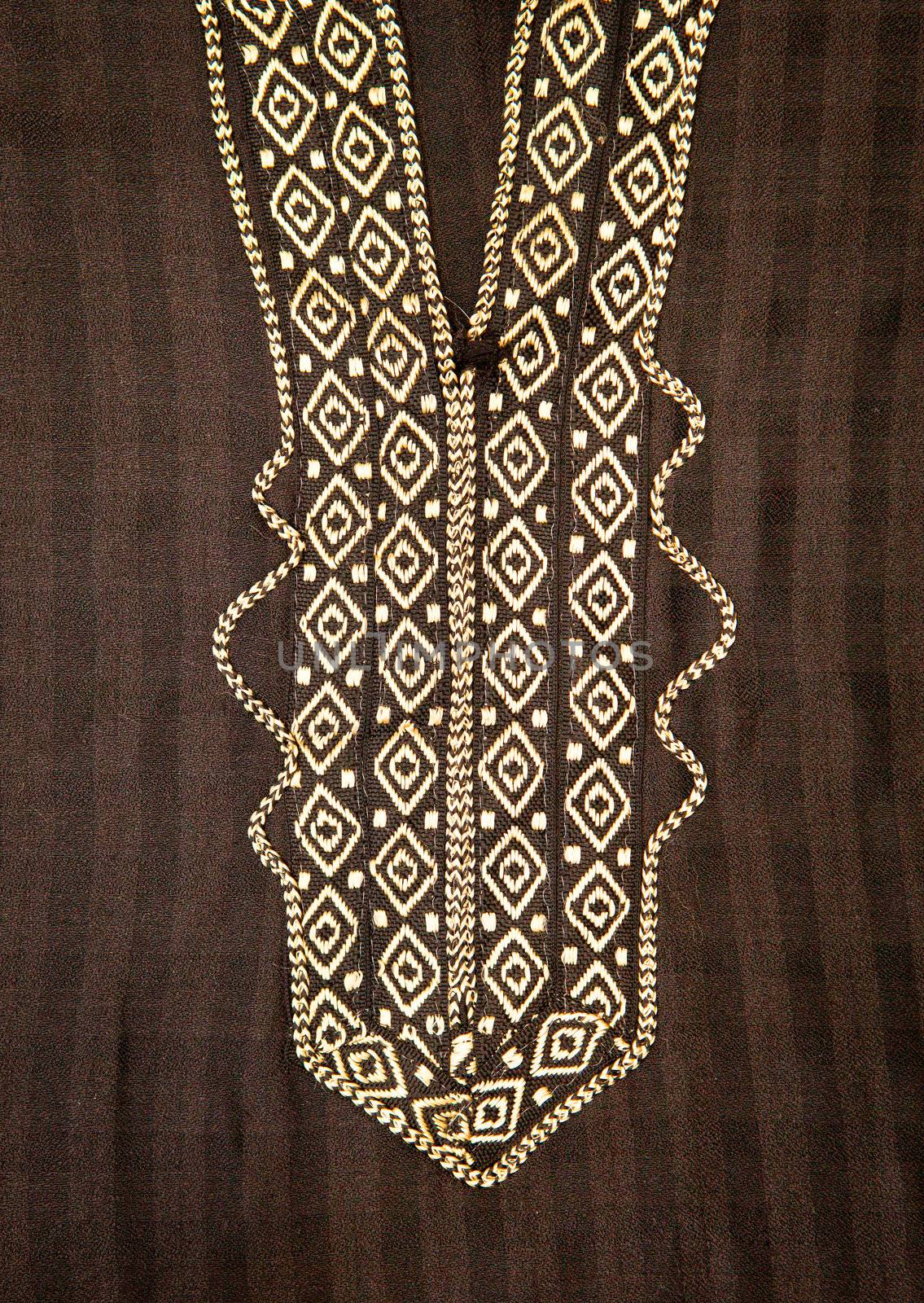 Close up of embroidered neck line on a black moroccan men's robe