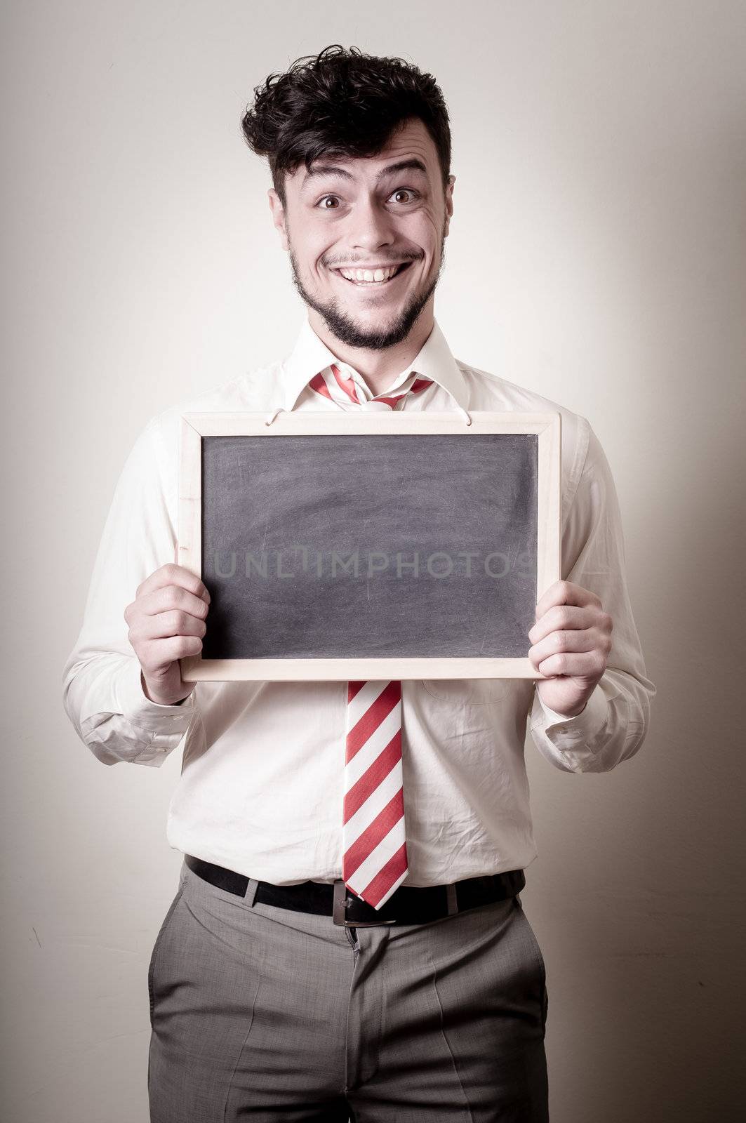 businessman with a blank blackboard on gray background