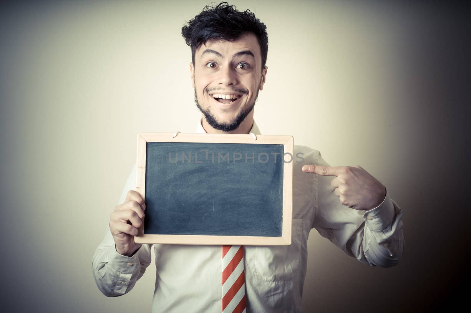 businessman with a blank blackboard on gray background
