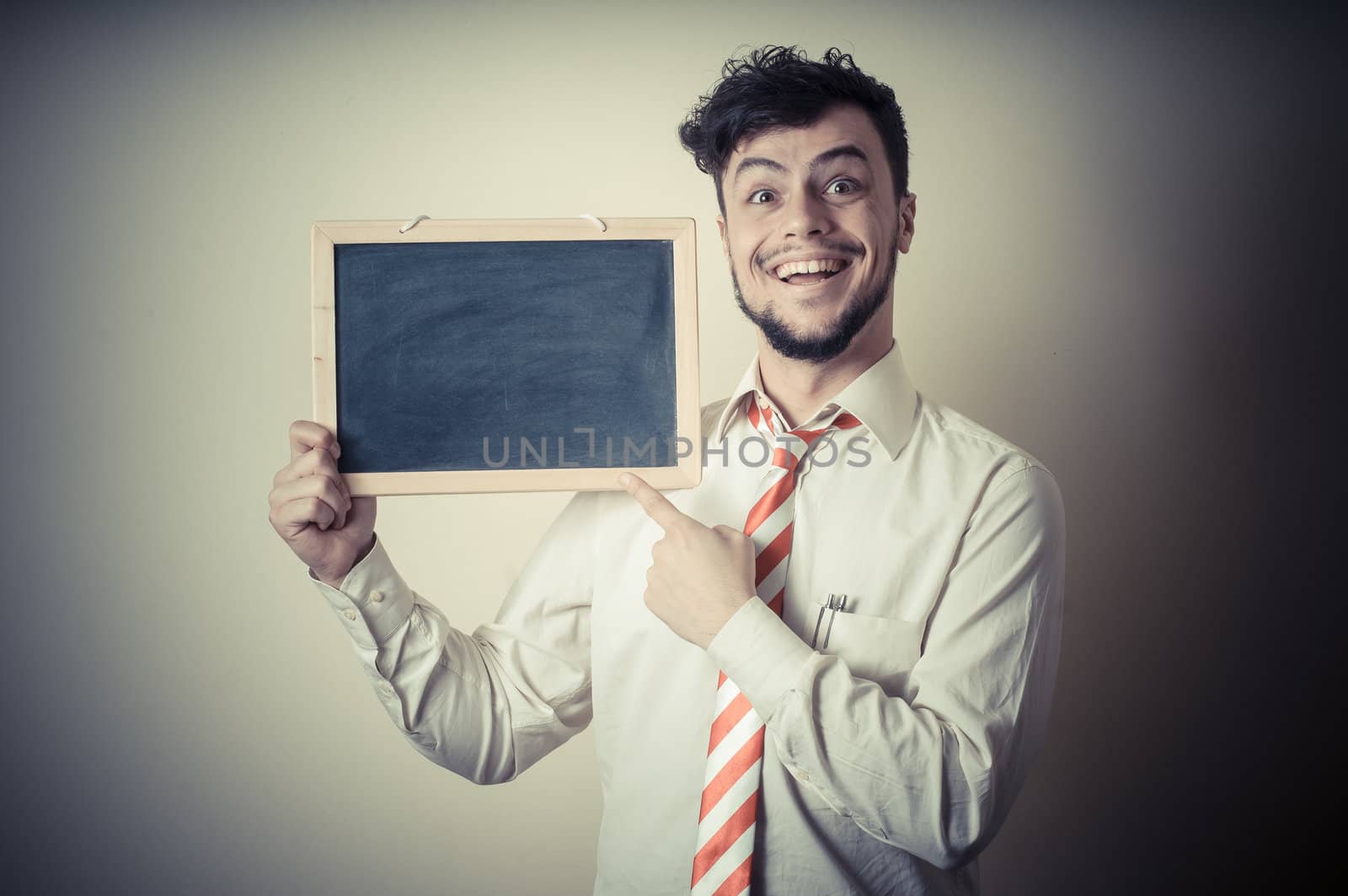 businessman with a blank blackboard on gray background