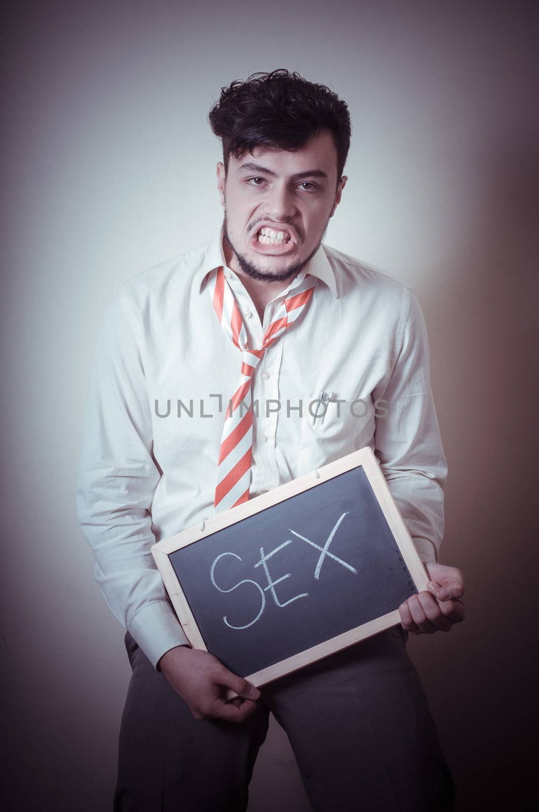 businessman with a blank blackboard write sex on gray background