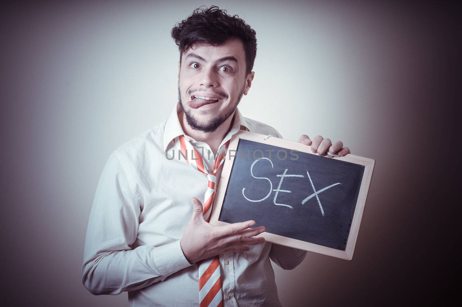 businessman with a blank blackboard write sex on gray background