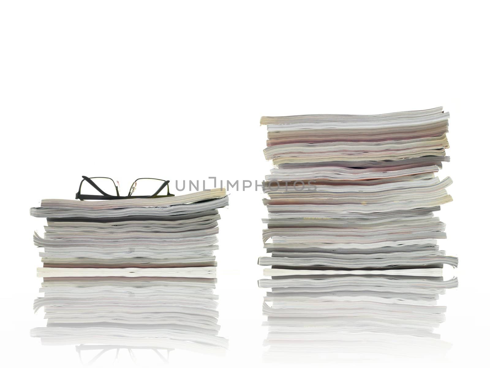 A stack of magazines isolated against a white background