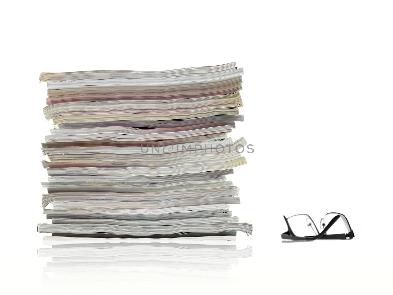 A stack of magazines isolated against a white background