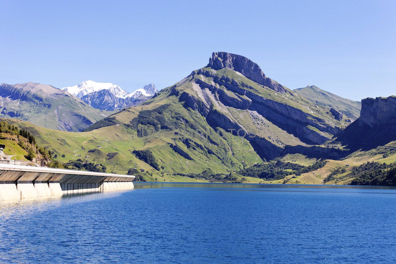 alpine landscape with lake and dam in France