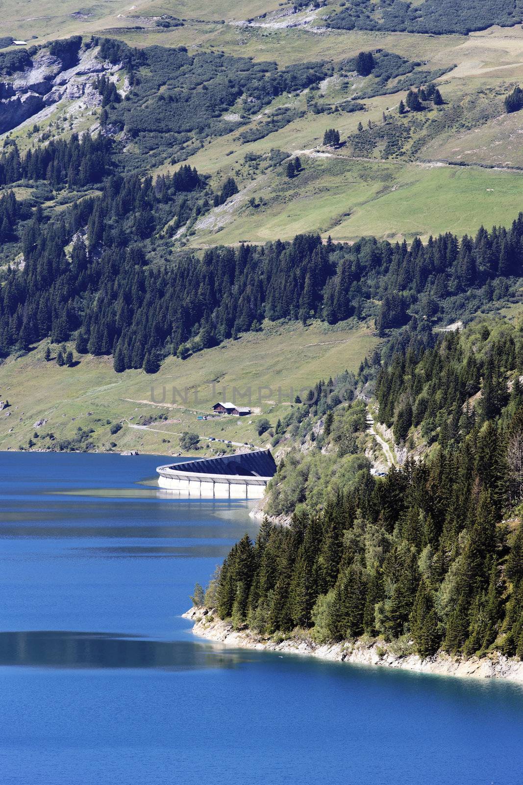 alpine landscape with lake and dam