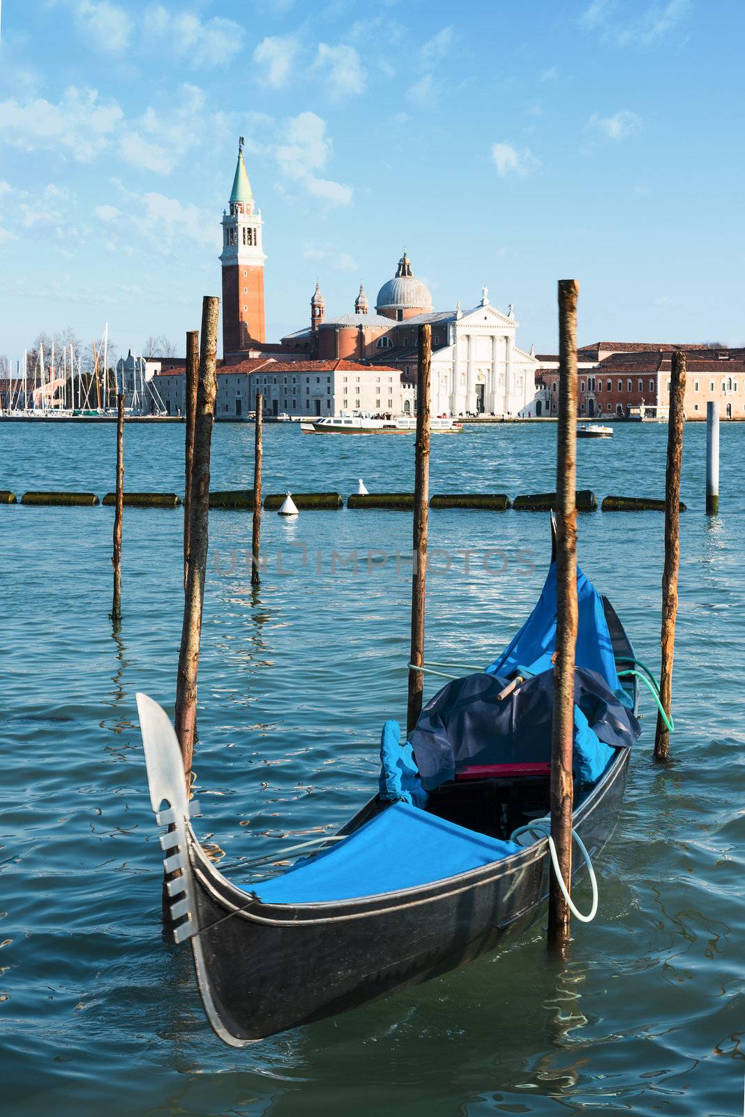 Gondolas moored by Saint Mark square with San Giorgio di Maggiore church in the background - Venice, Venezia, Italy, Europe 