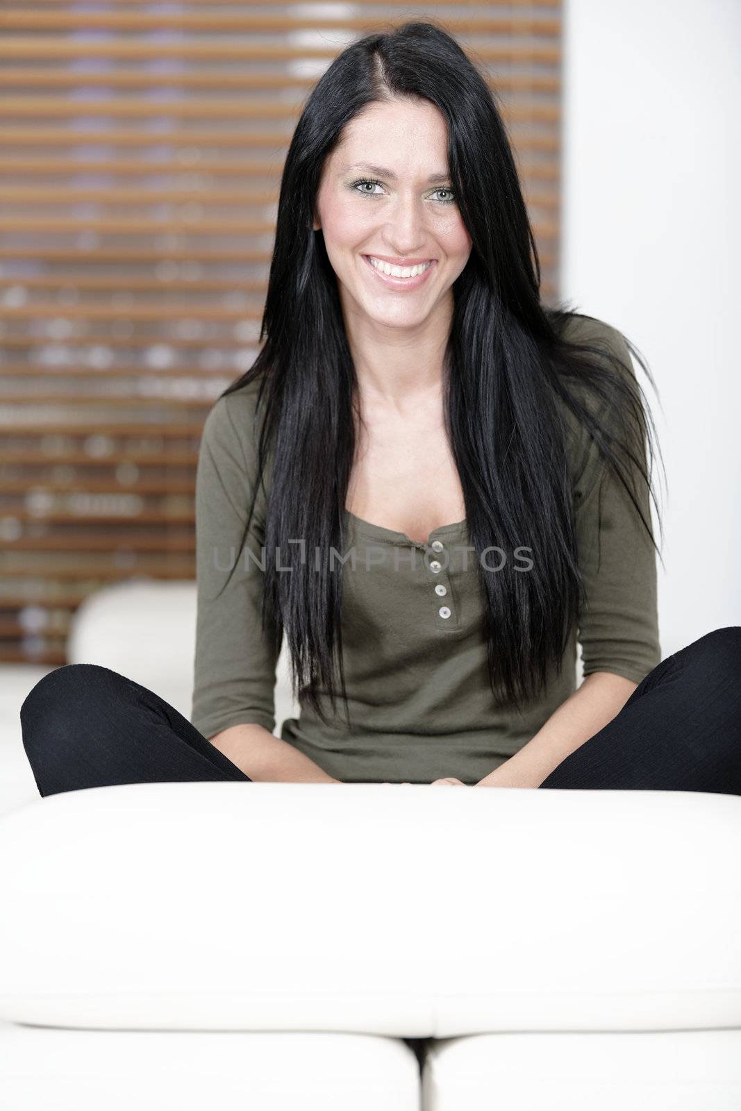 Attractive young woman relaxing on her sofa at home