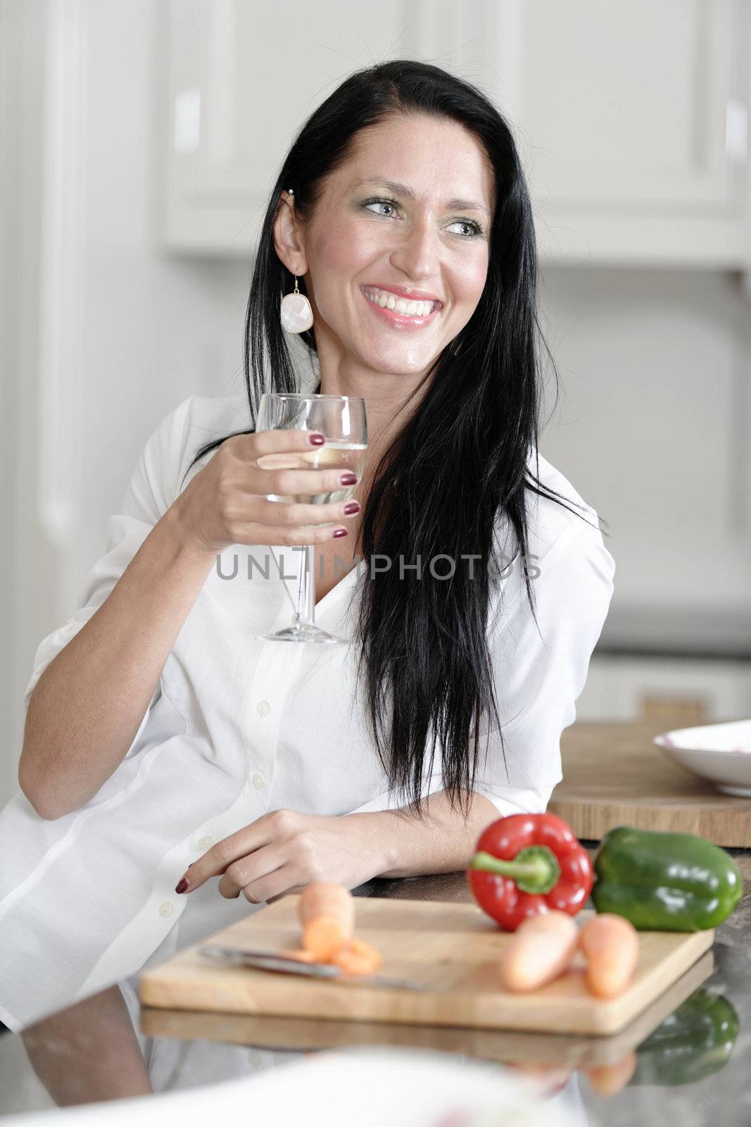 Woman preparing a meal in the kitchen by studiofi