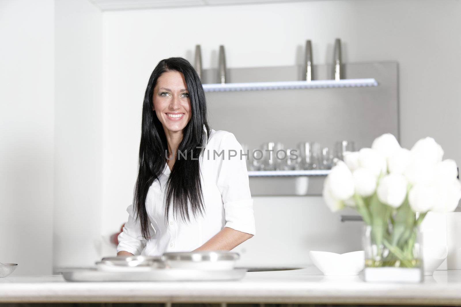 Attractive young woman in her elegant kitchen
