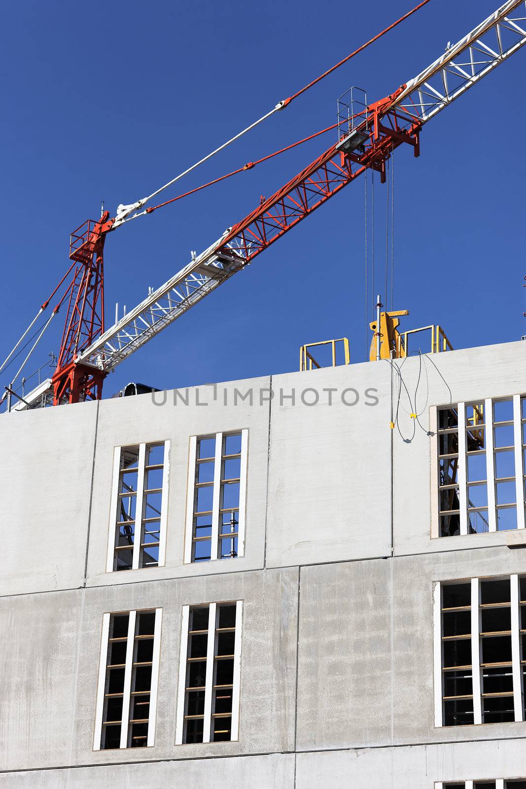 Construction site with crane and building in blue sky