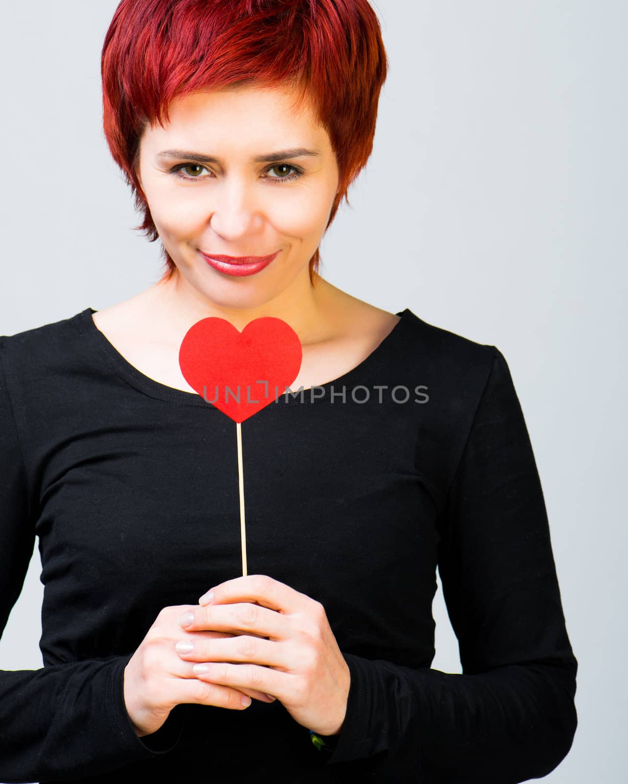 young nuce woman with a red paper heart