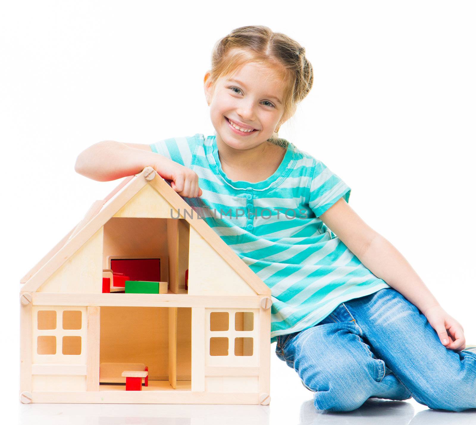 cute little girl with a toy house