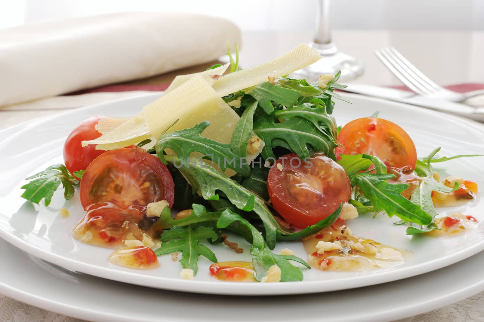 Spicy salad of arugula and cherry tomatoes with parmesan sauce