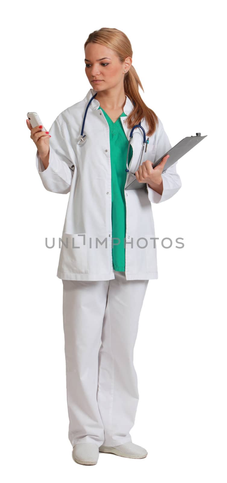 Young blonde woman doctor reading a phone message, isolated against a white background.