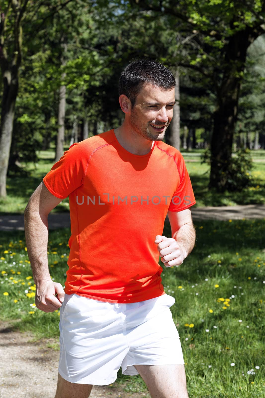 man running in a park in spring