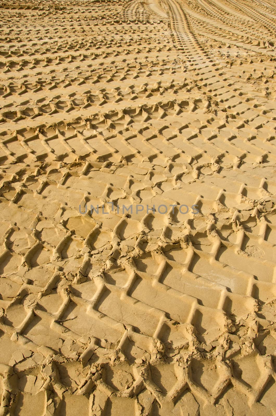 sand in industrial quarry background and texture with wheel tracks