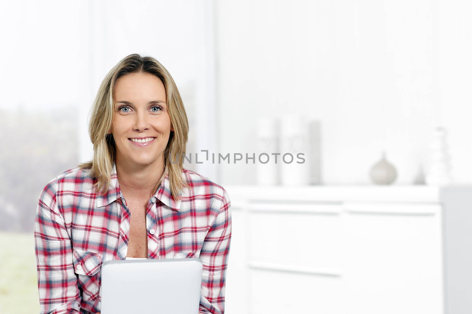 beautiful blond woman at home with tablet