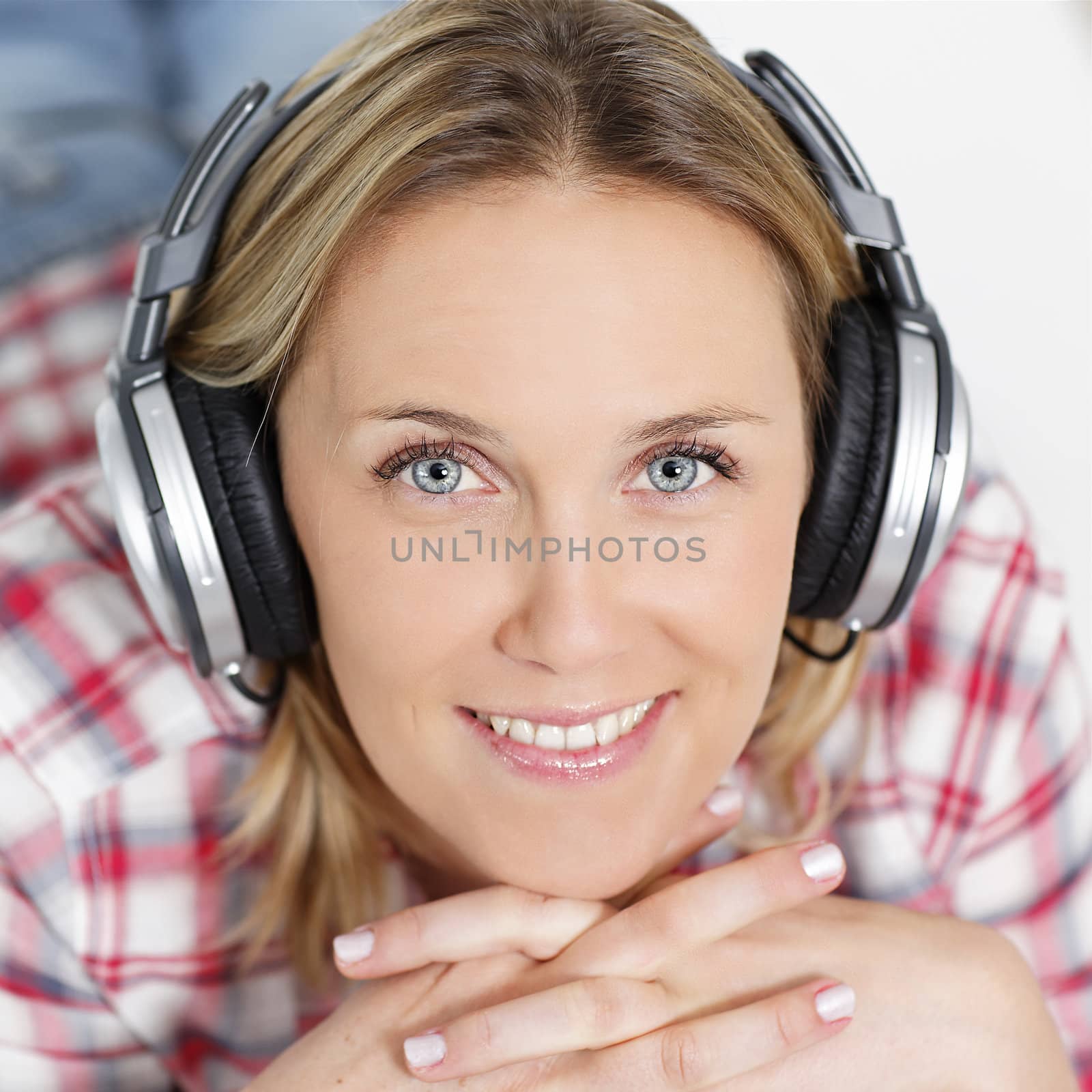 beautiful blond woman listening music with headphones