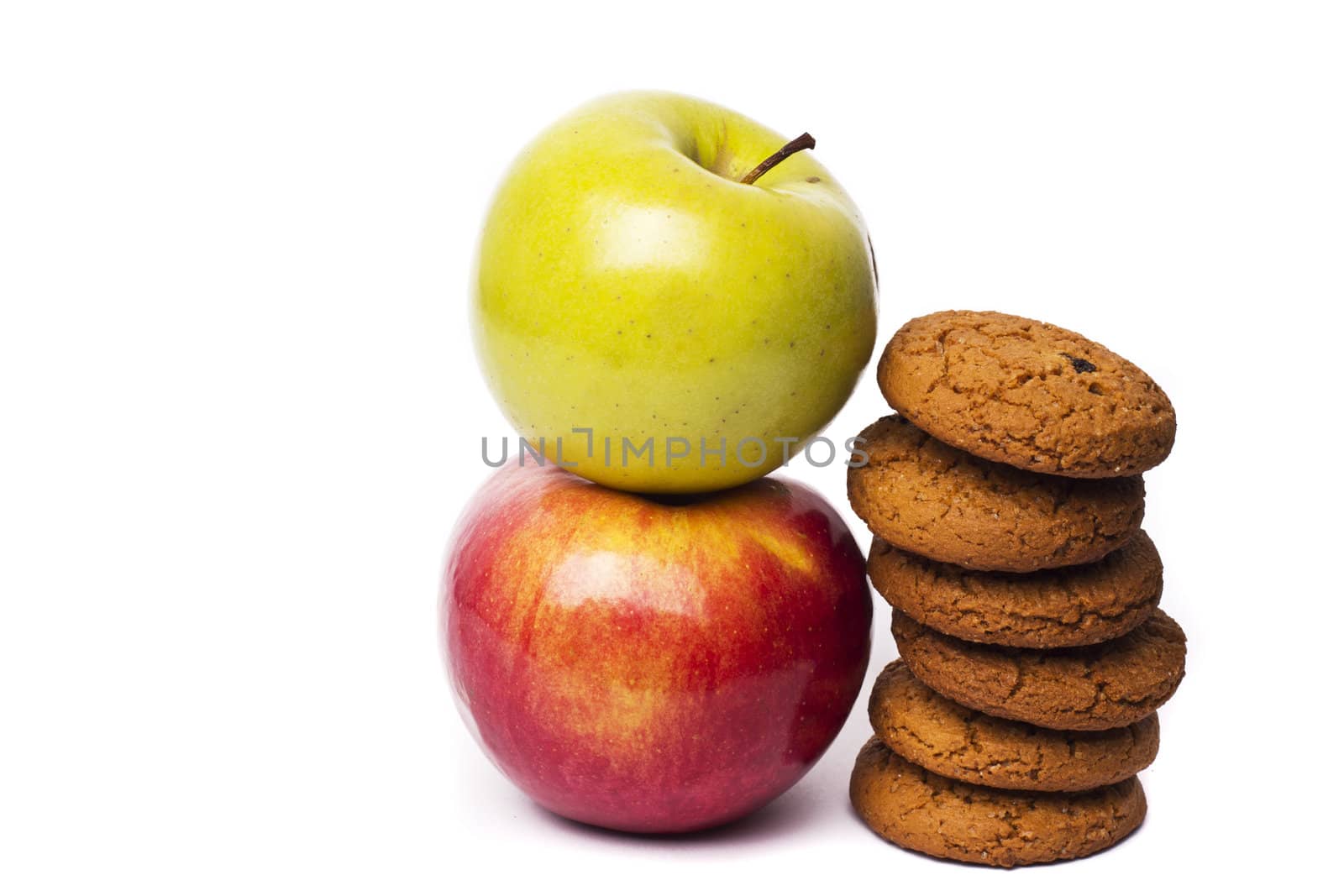 Two apples, Red Delicious and Green, isolated on white background with cookies
