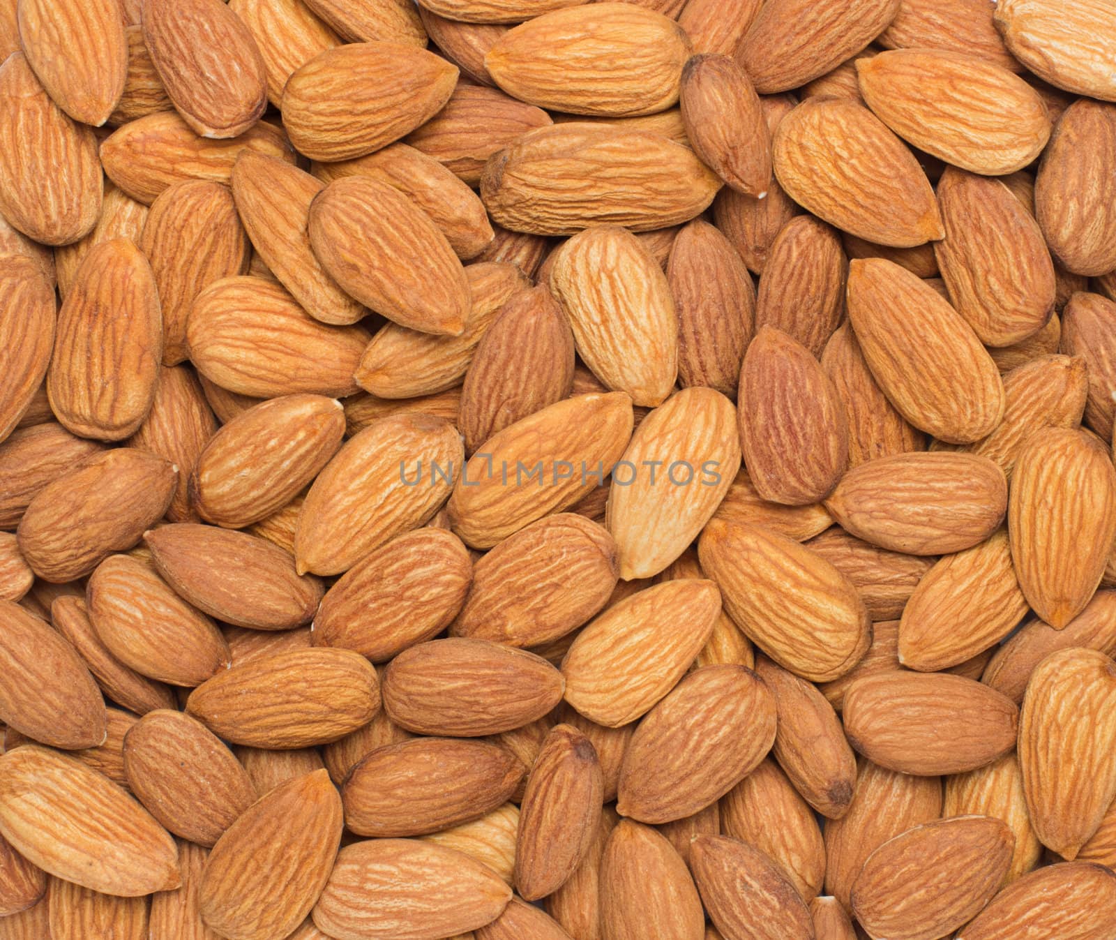 Pile of almonds close-up as background.