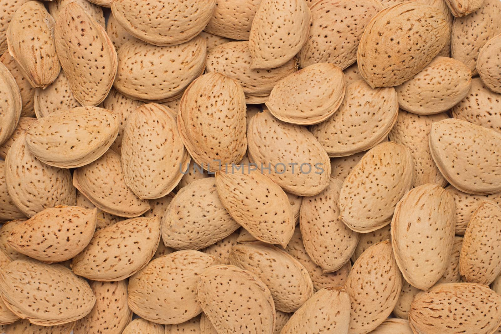 Pile of almonds close-up as background.