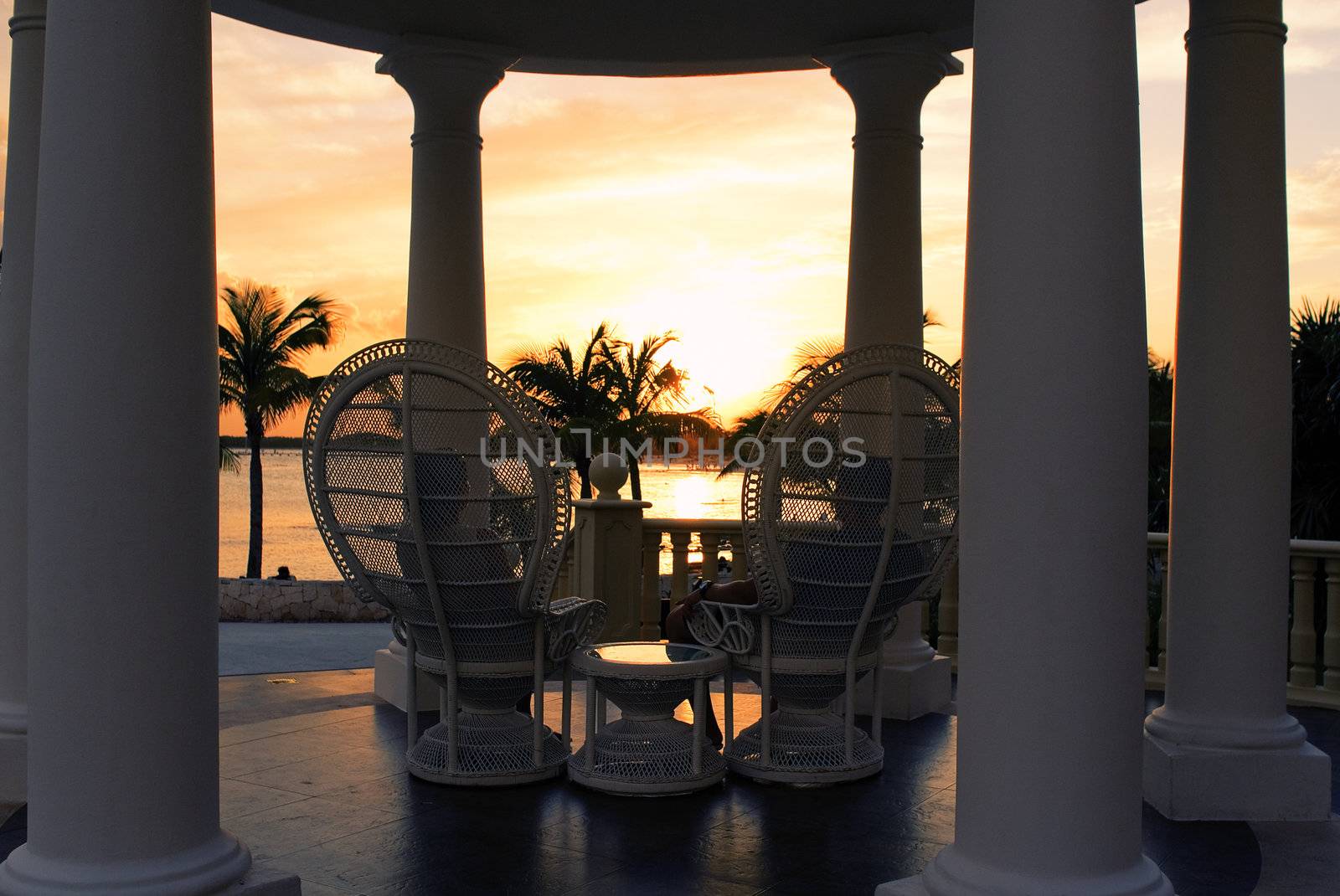 couple on seat face the sea and sunset in summer