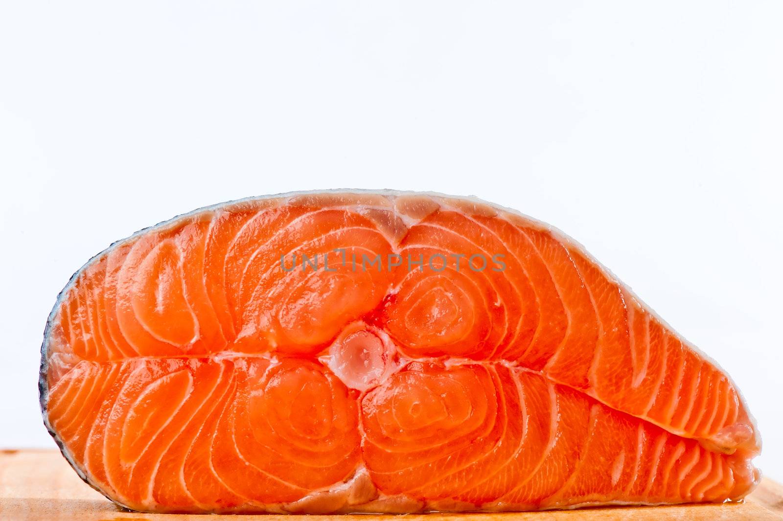 Red is a piece of salmon on a white background by kosmsos111
