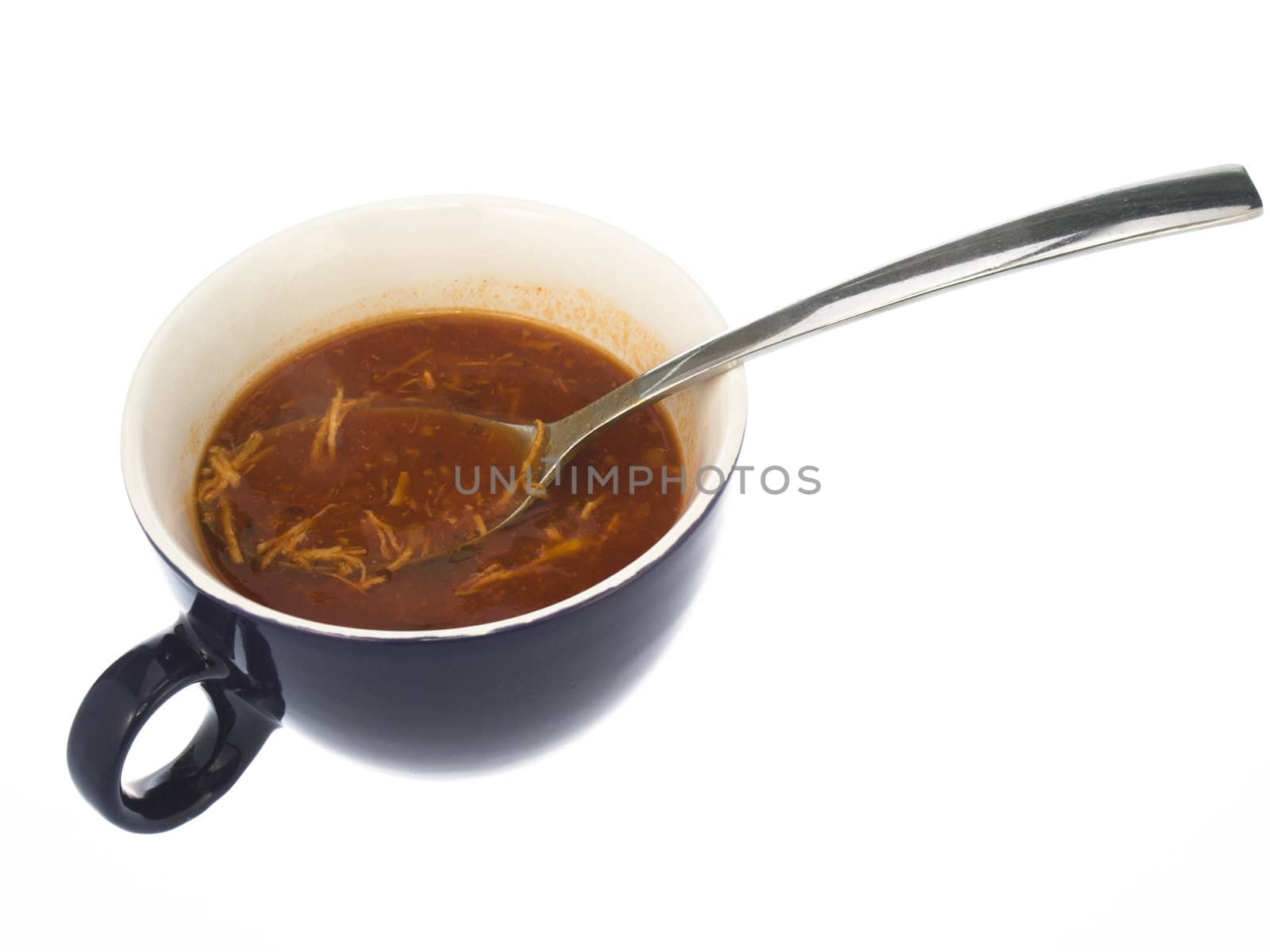 cup of soup with a spoon on a white background