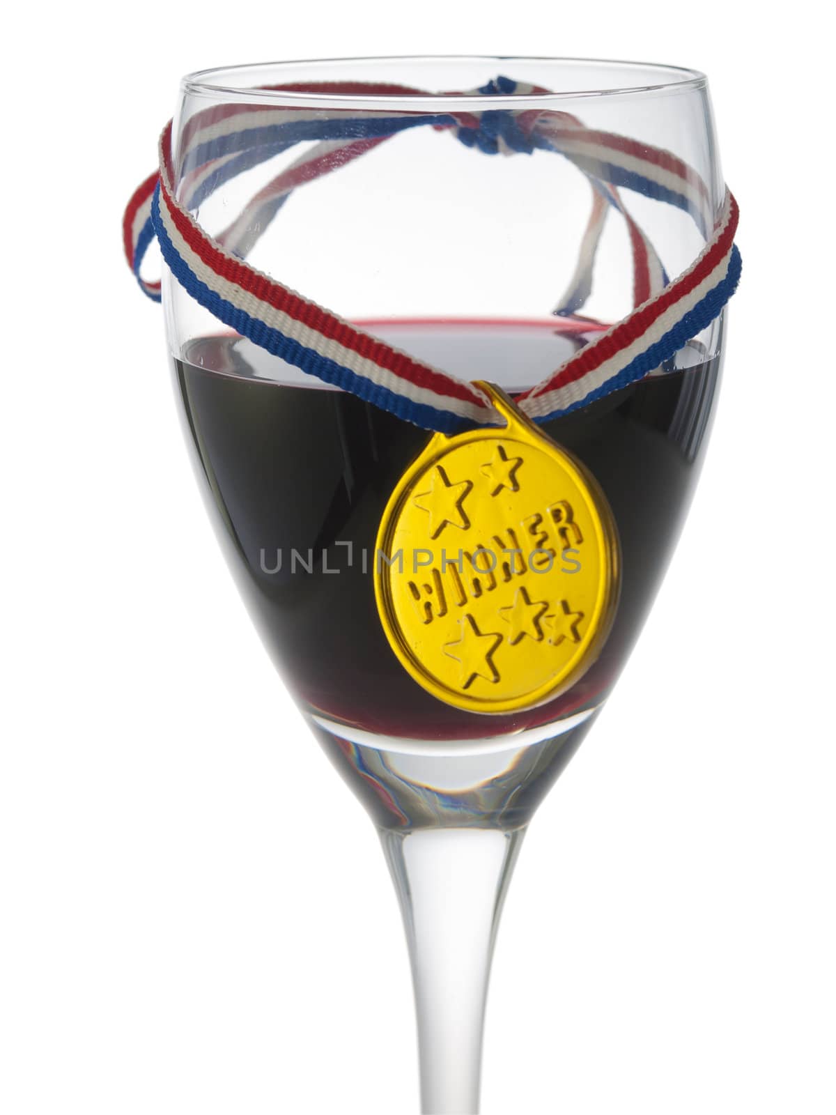 Glass with red wine with a medal winner