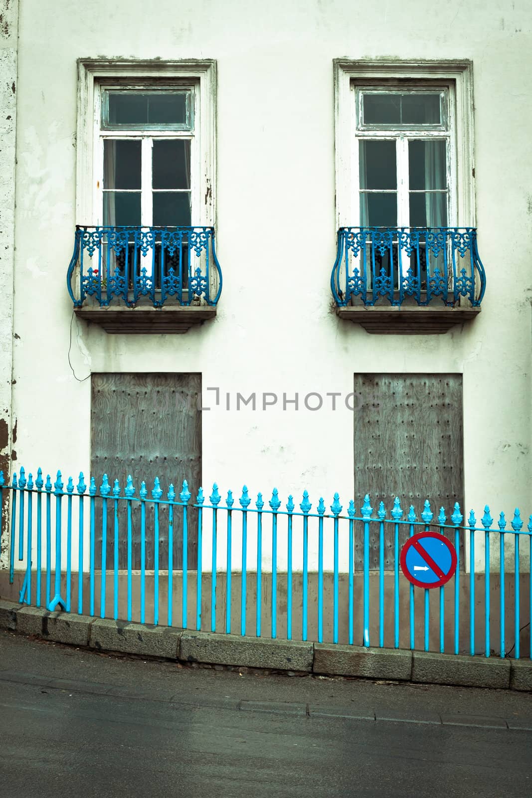 Derelict house with boarded up windows in a UK town