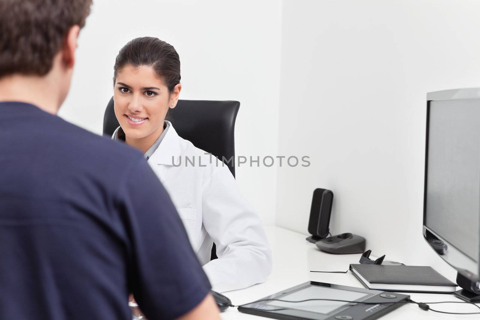 Smiling Female Doctor Talking to Patient by leaf