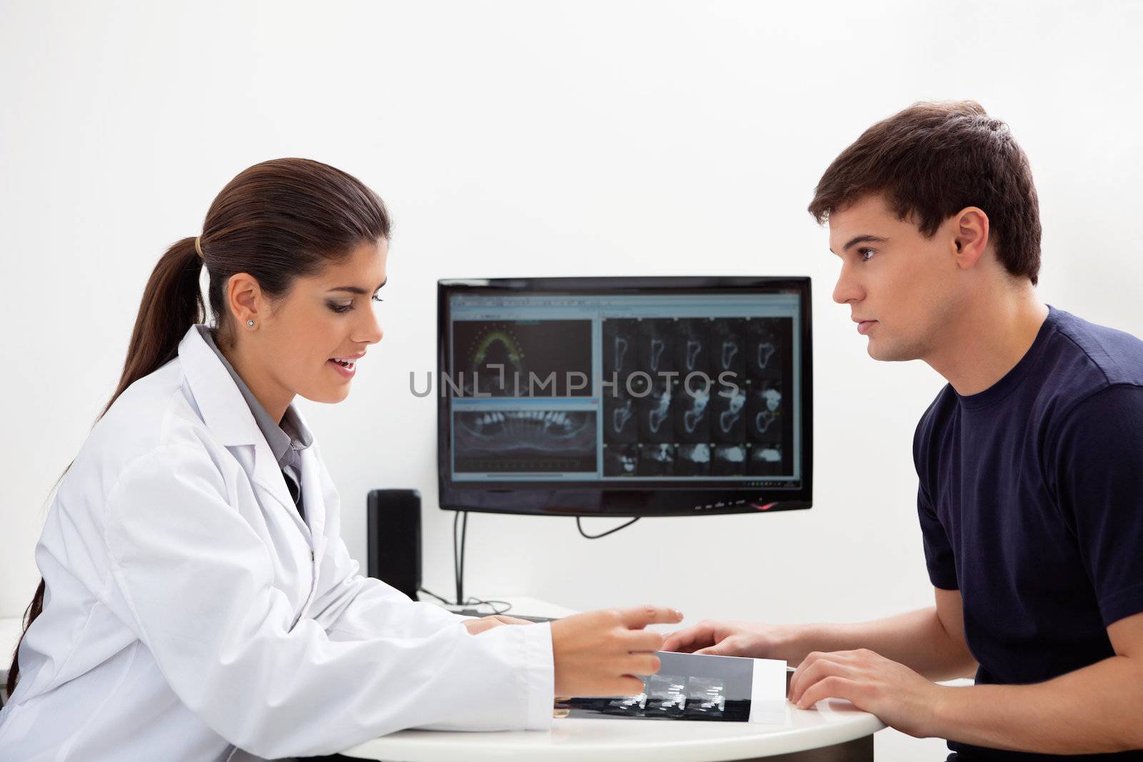 Dentist discussing report by leaf