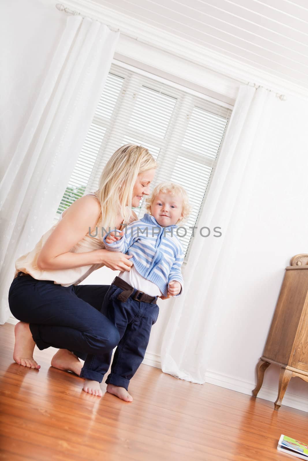 Full length of young mother and cute little child at home