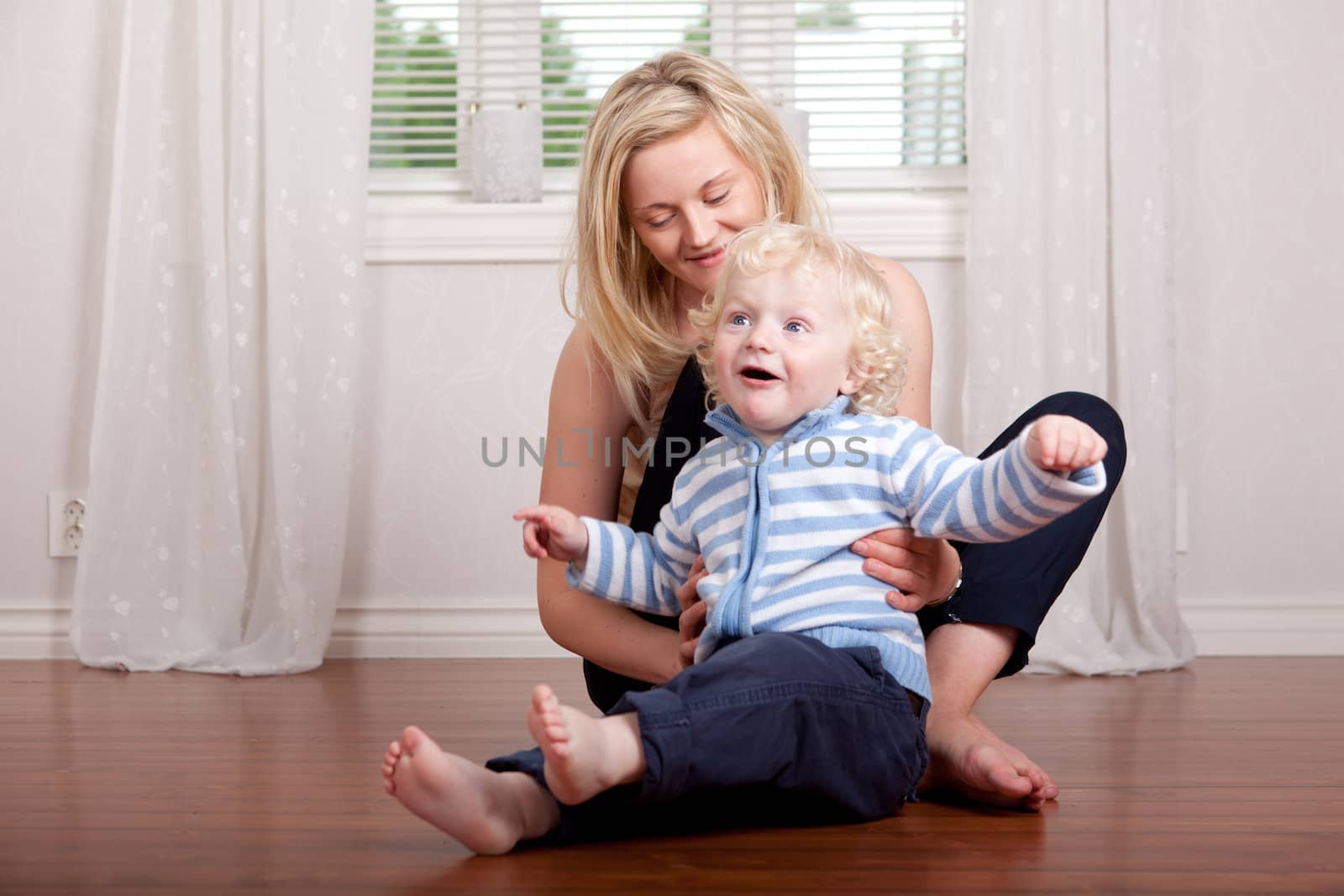 Boy and mother having fun at home