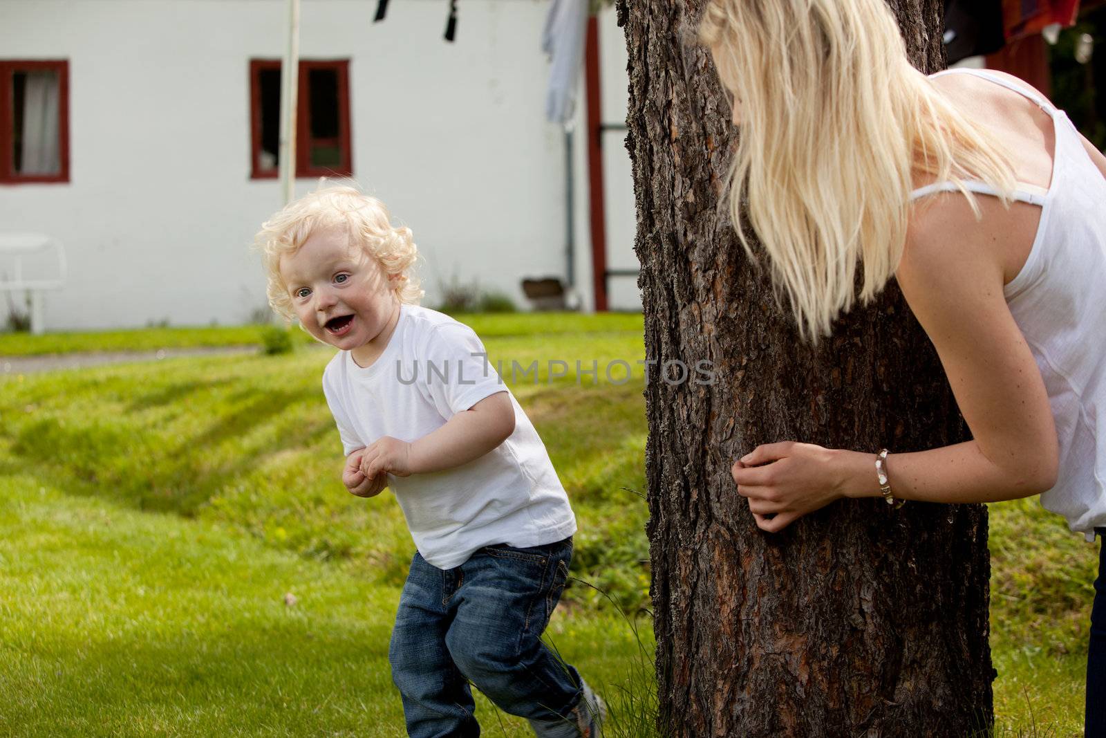 An extremely excited young boy looking for his mother playing hide and seek