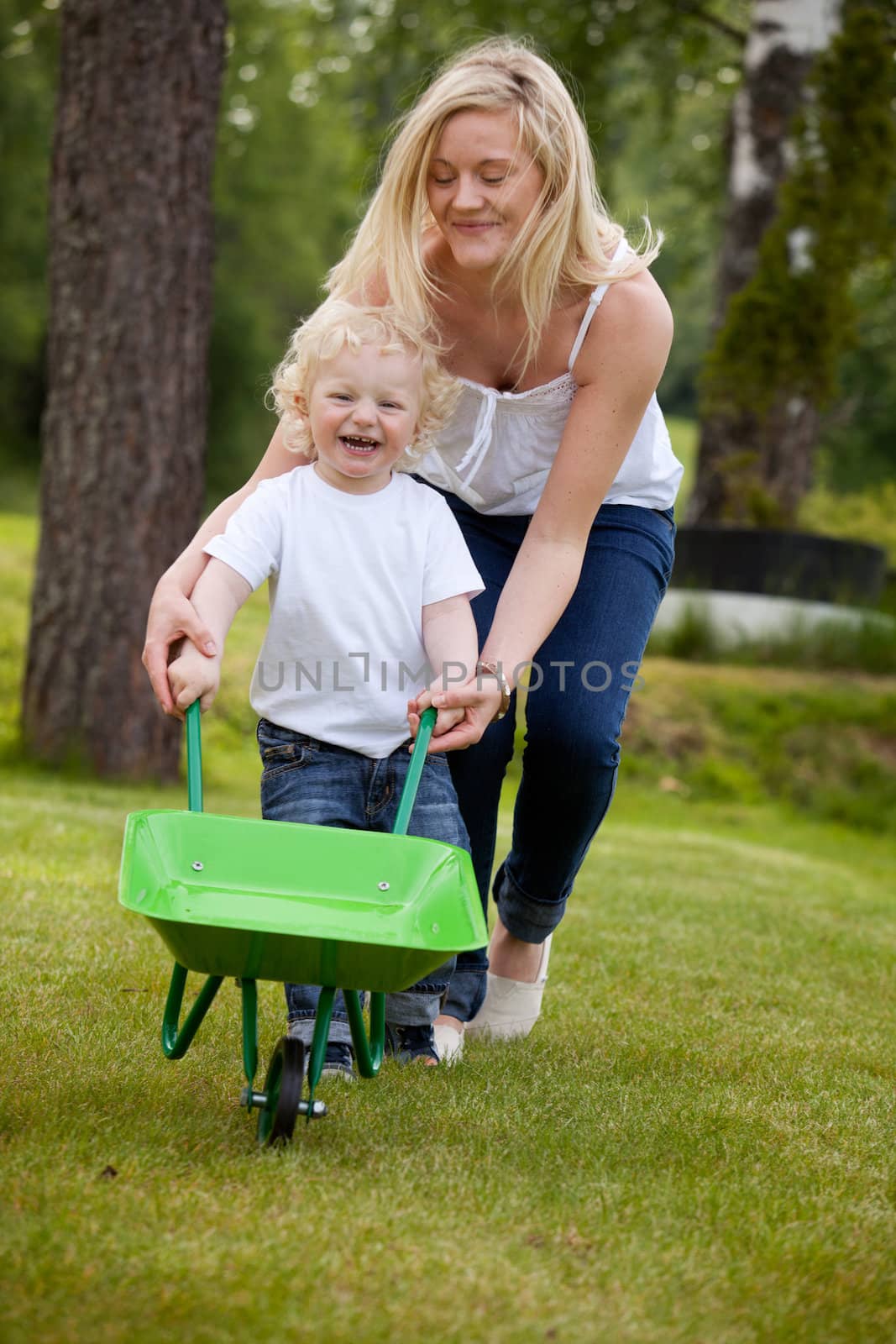 Mother and Child Playing Outdoors by leaf