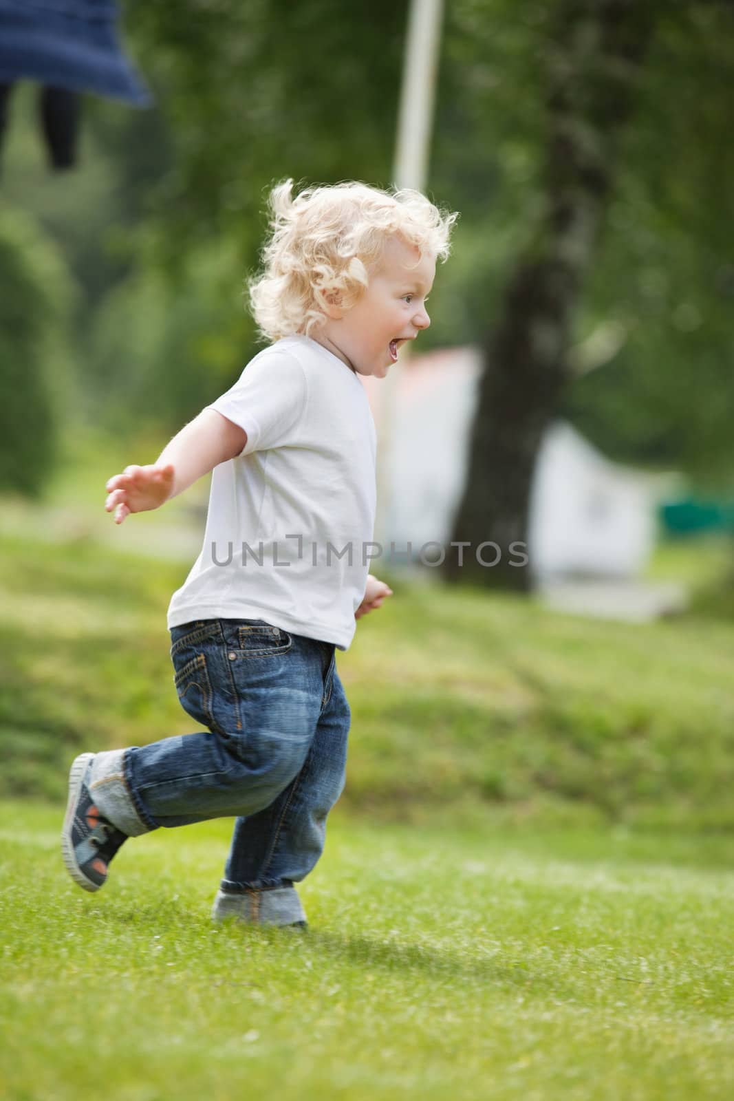Boy running in garden by leaf