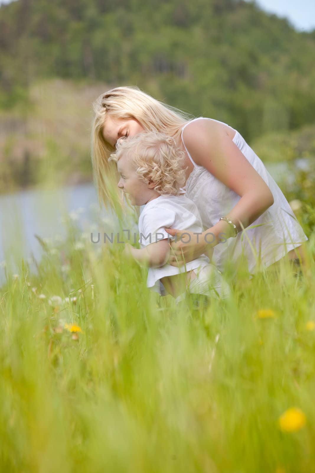 Mother holding excited boy looking into the distance