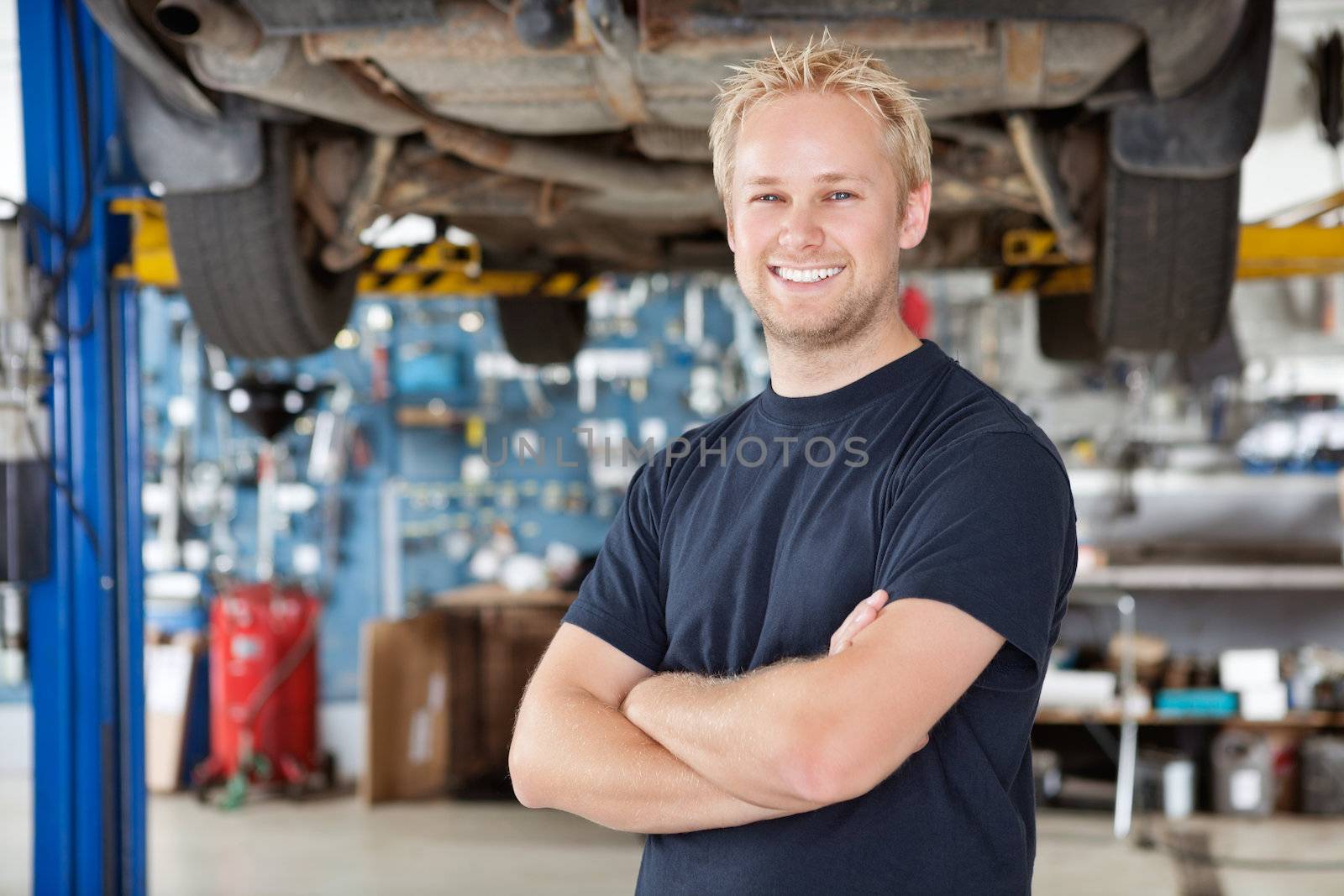 Portrait of Smiling Mechanic by leaf