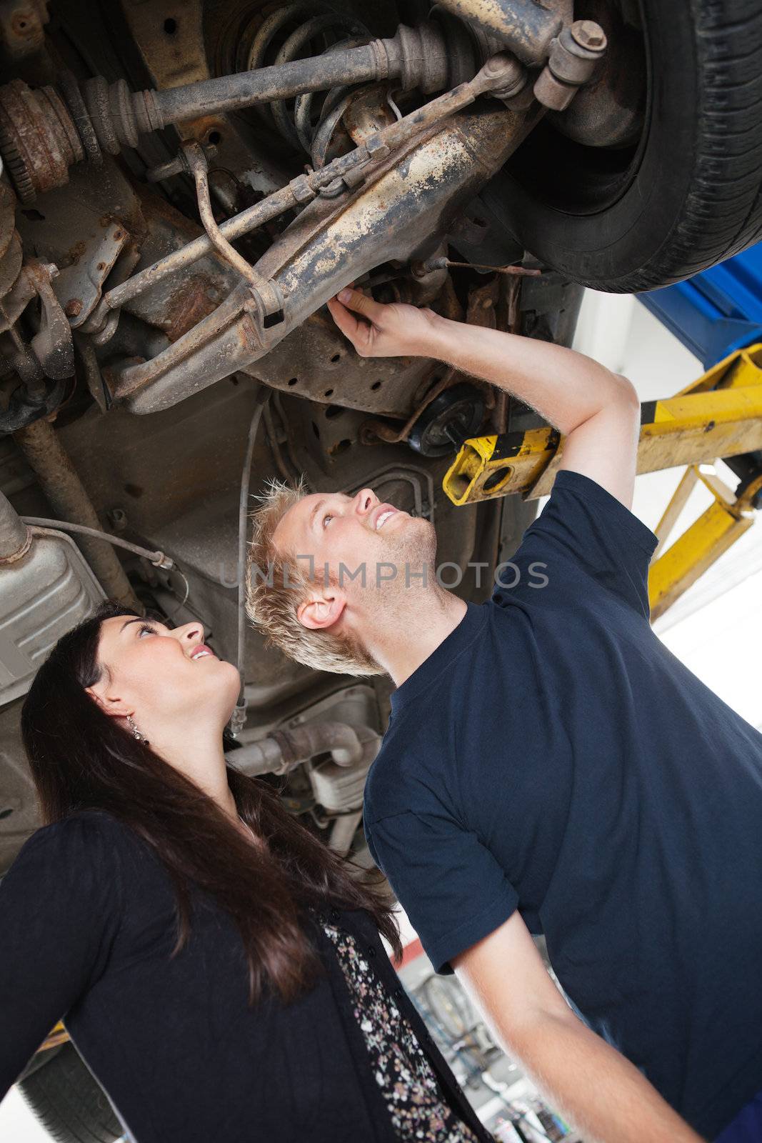 Mechanic showing female customer problems with car