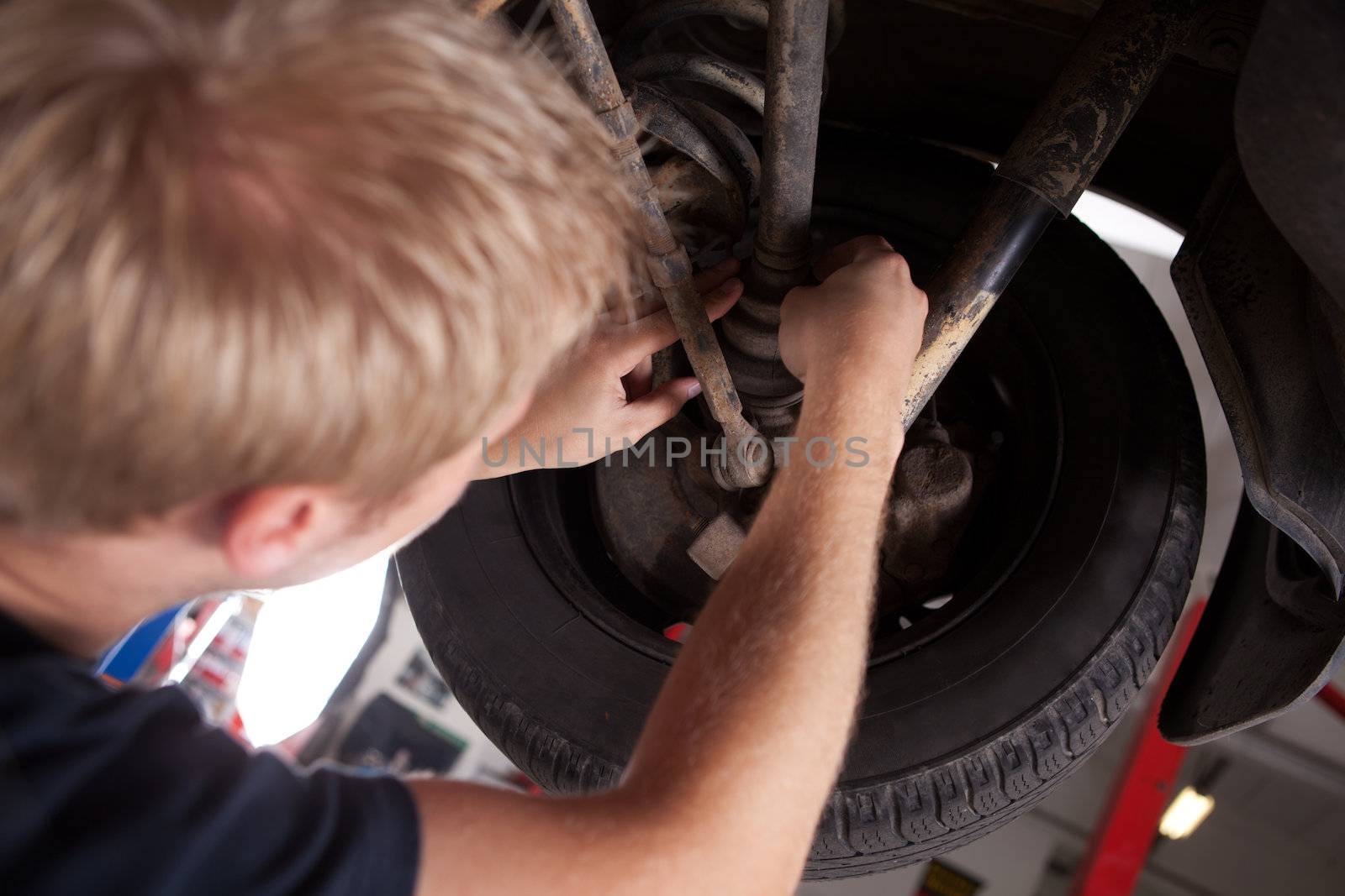 Mechanic Inspecting CV Joint by leaf