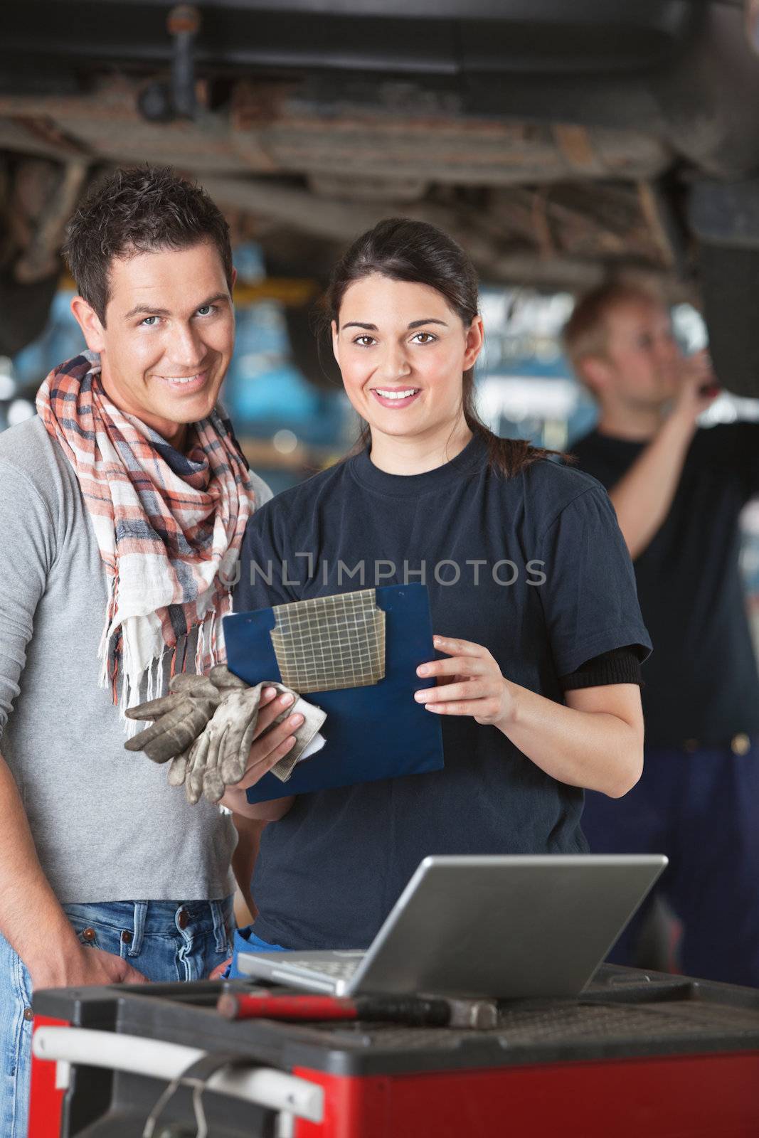Female mechanic with customer by leaf