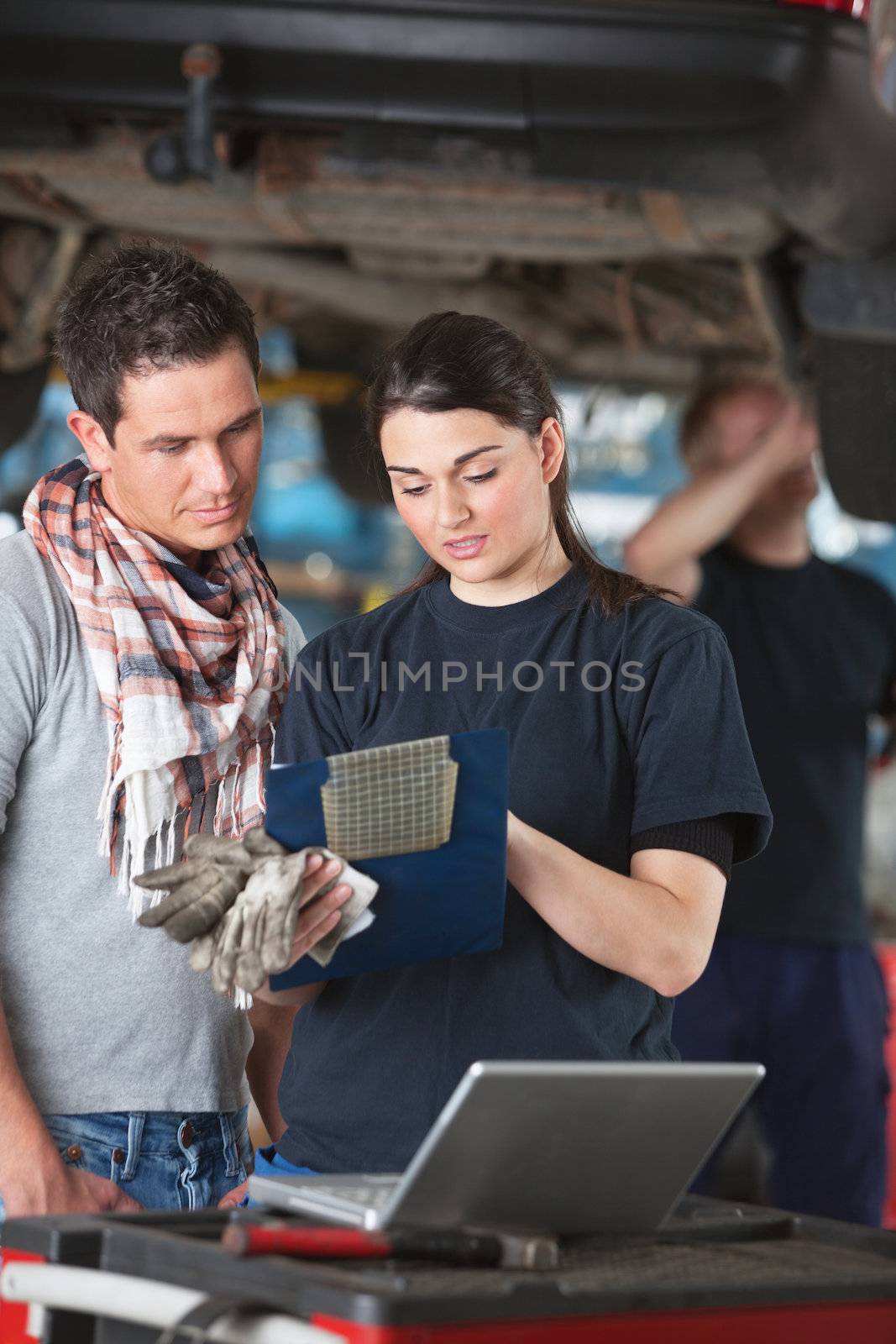 Female Mechanic Explaing Repairs to Client by leaf