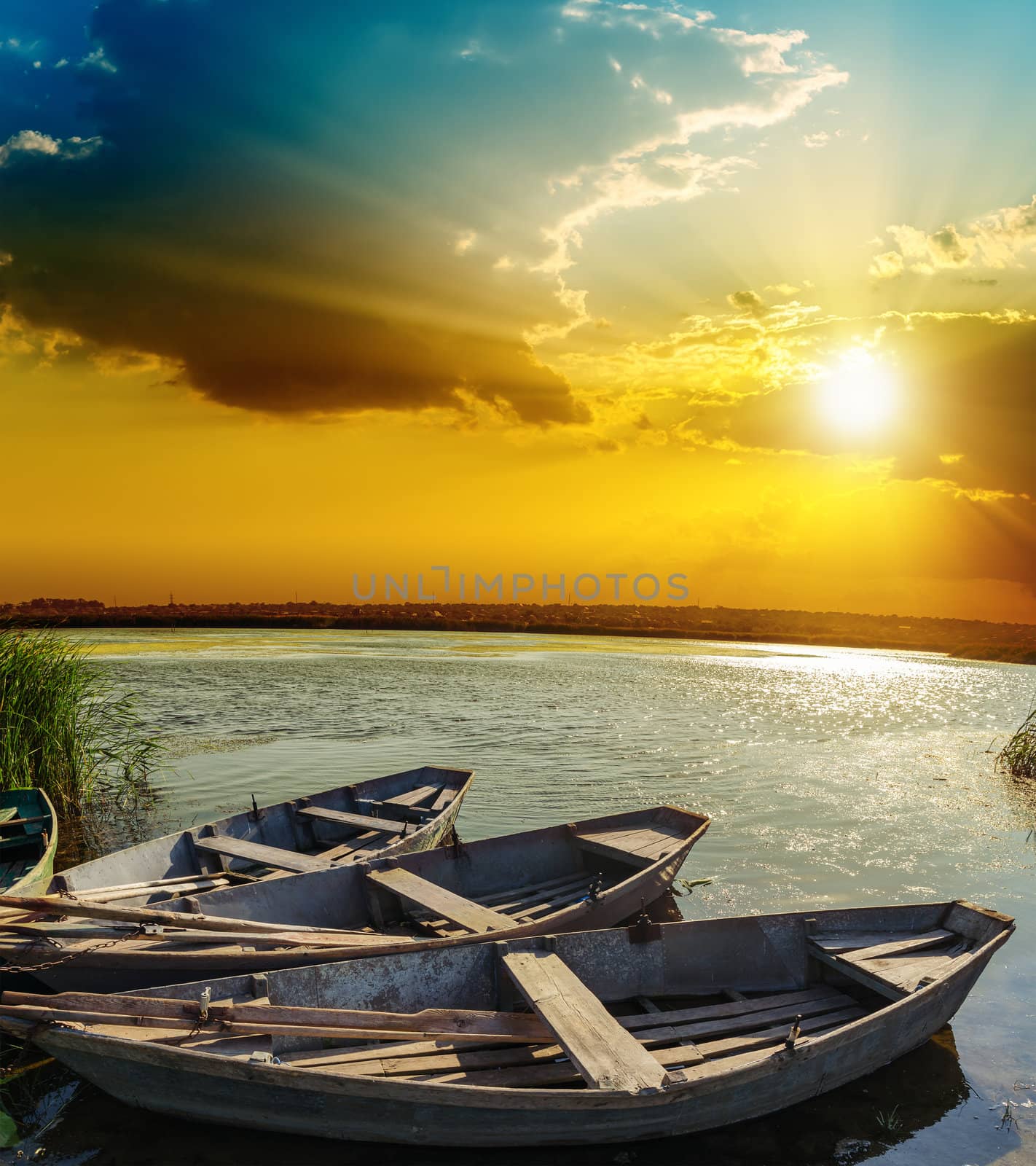 boats on water under sunset by mycola