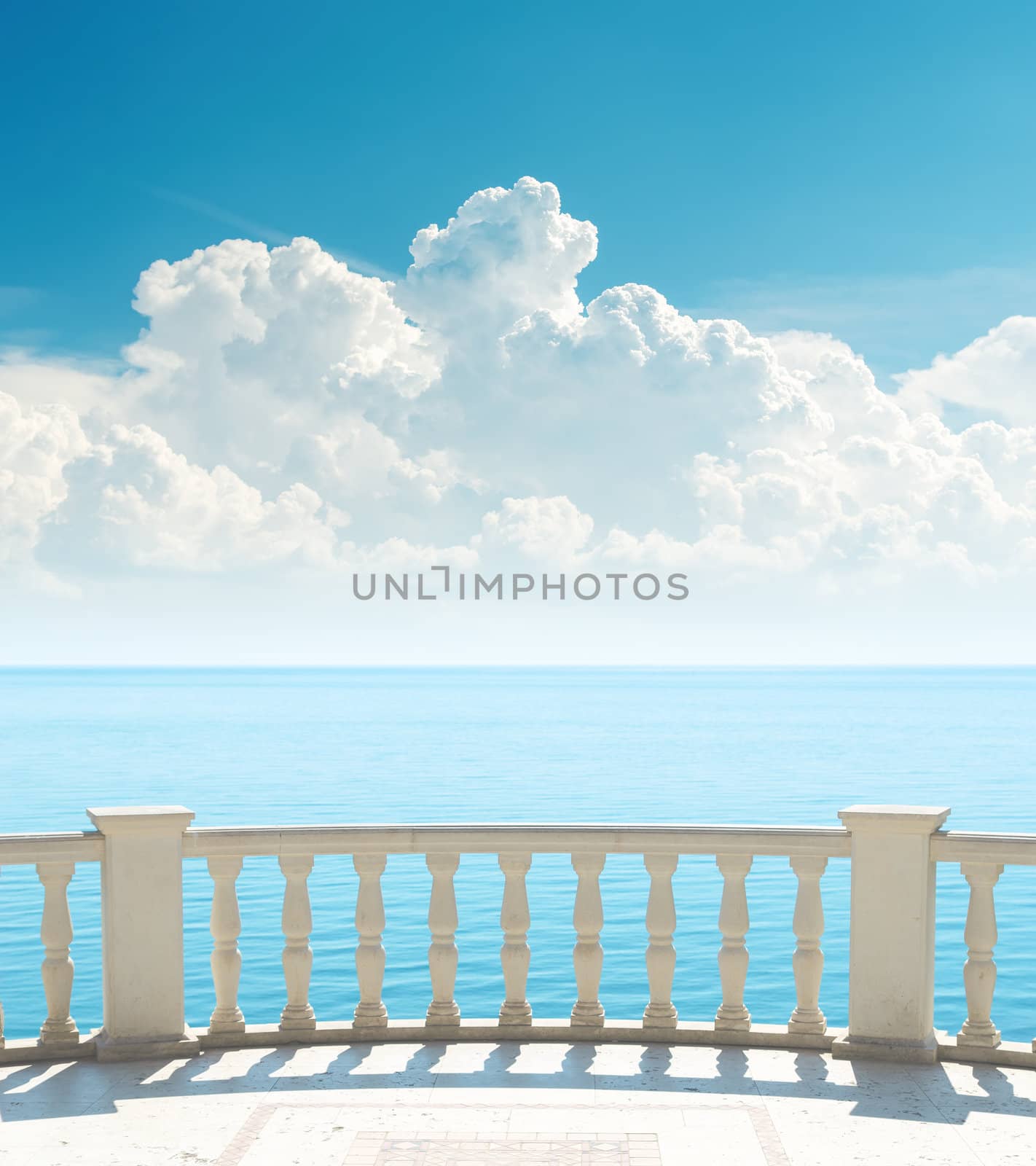 balcony near sea and clouds over it