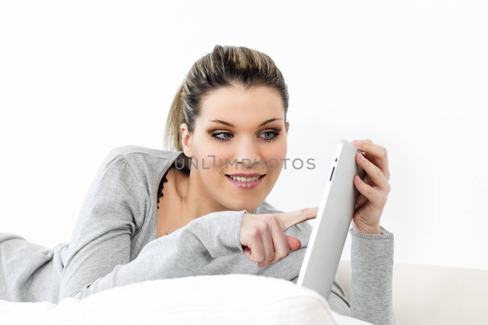 beautiful woman on sofa with tablet at home