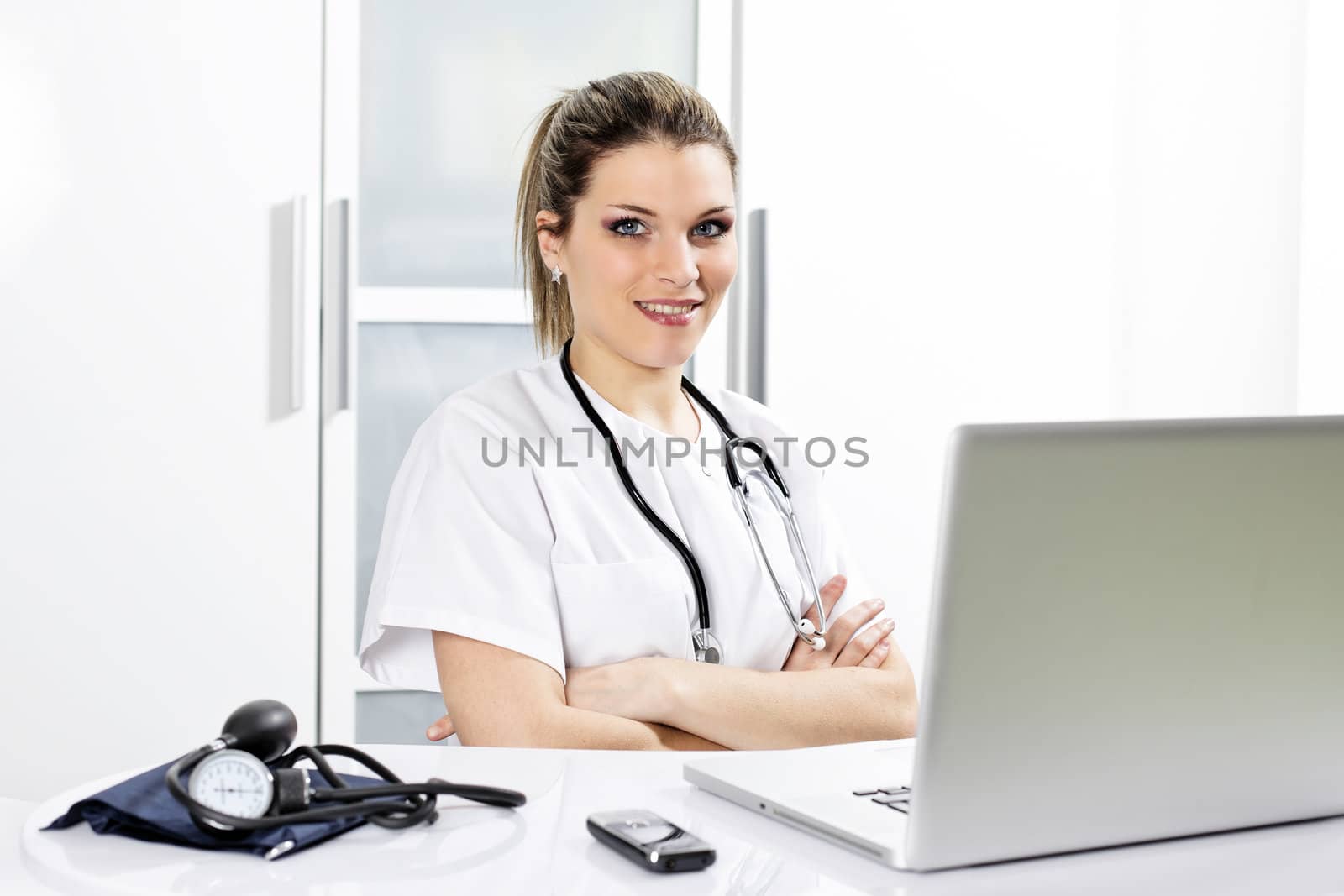 young woman doctor in hospital with computer
