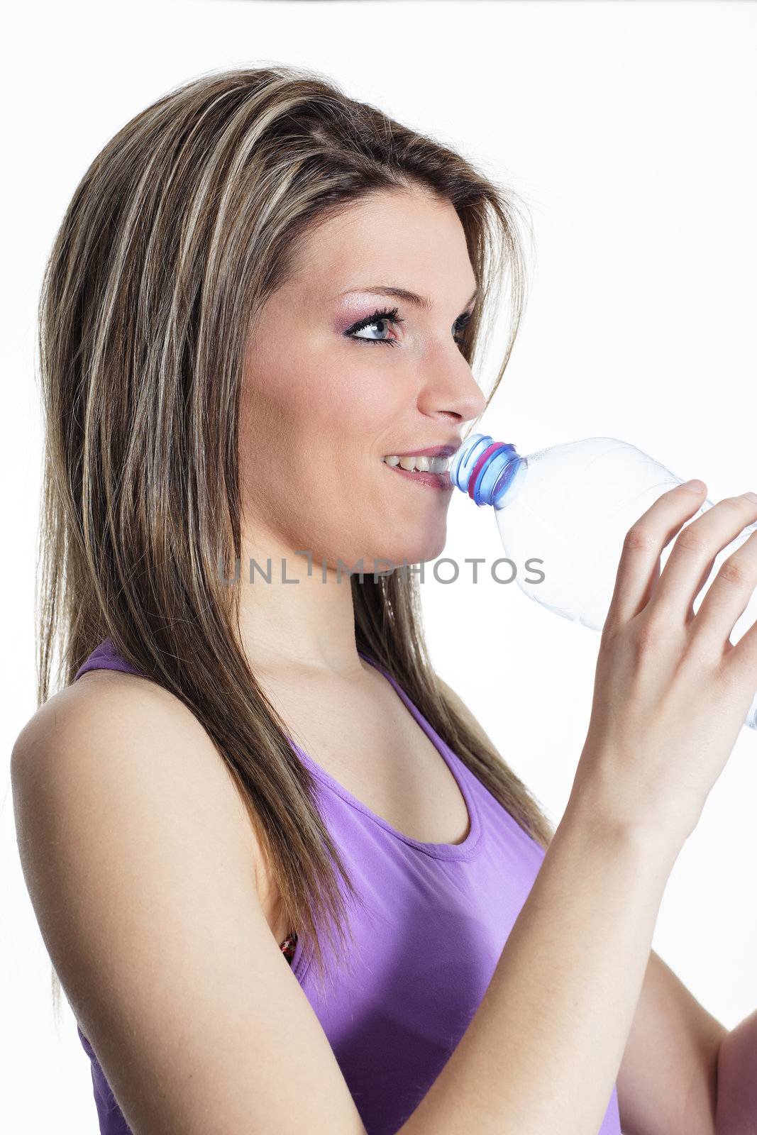 woman drinking water after sport