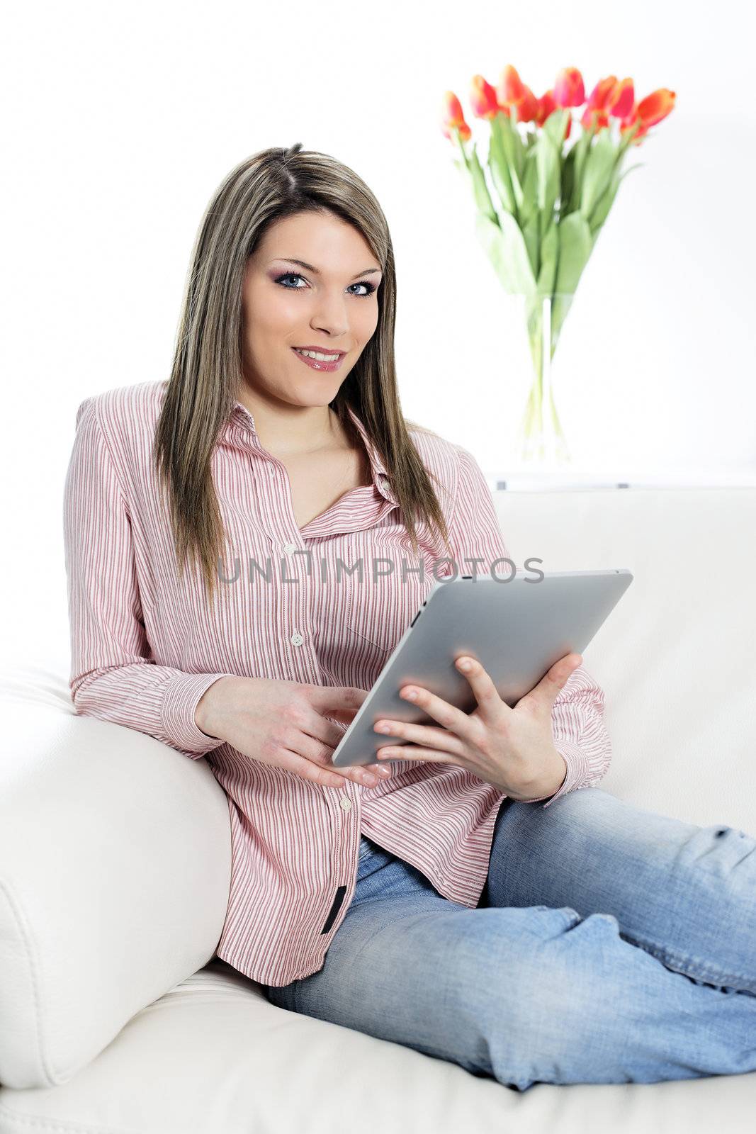 woman at home on sofa with tablet